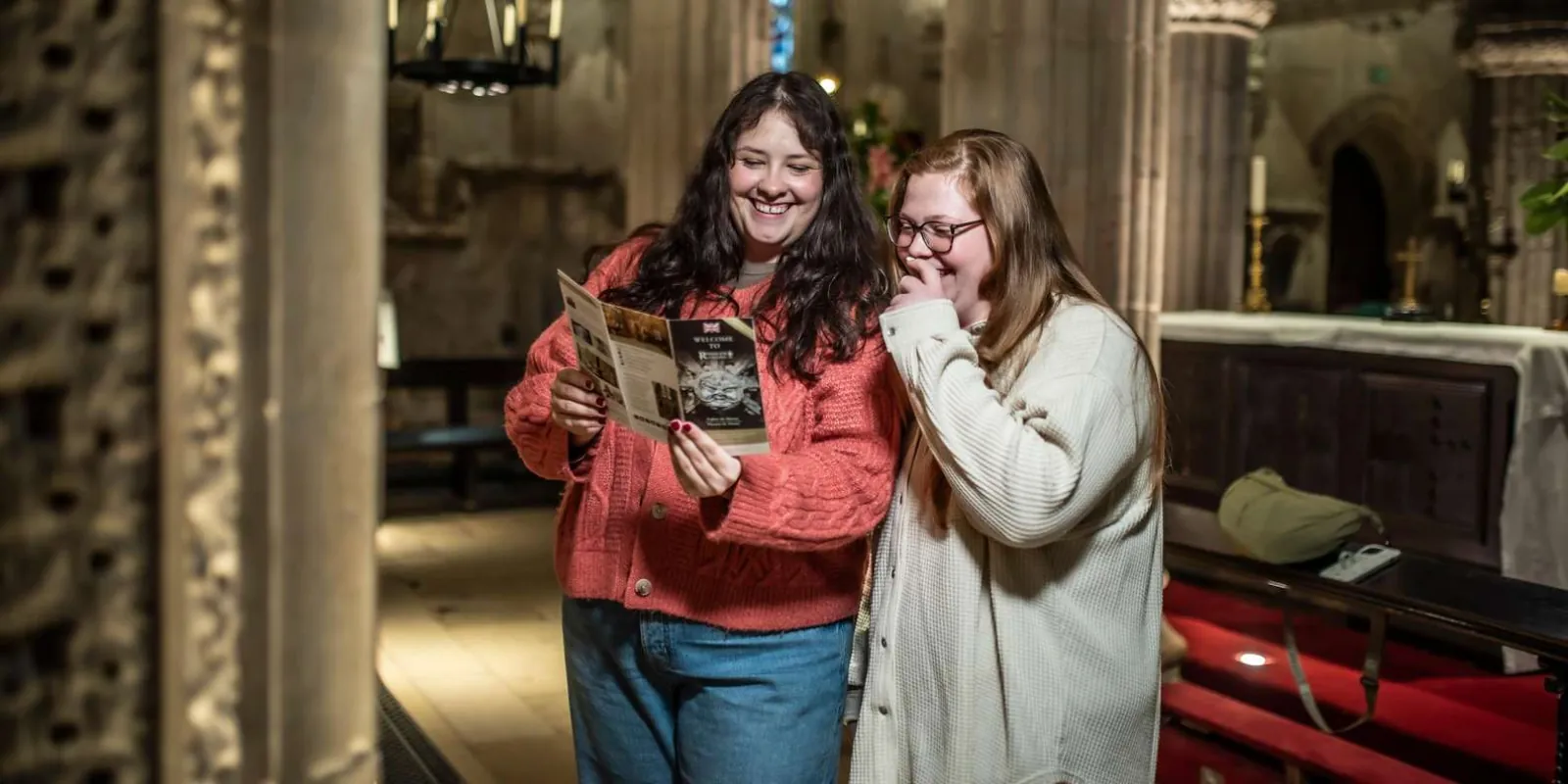 Visitors examining the carved stonework inside Rosslyn Chapel
